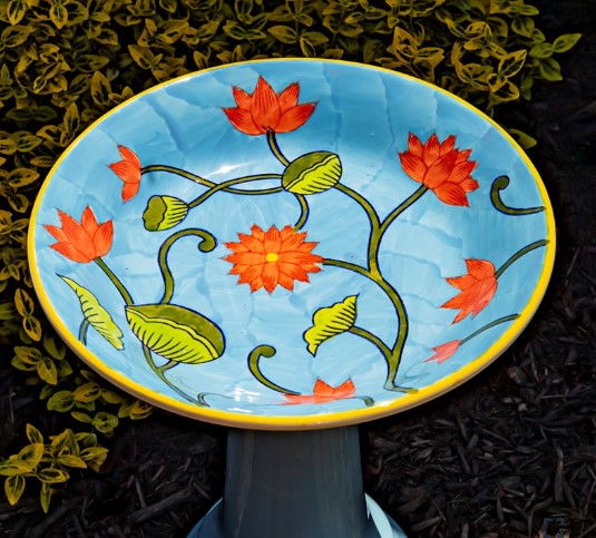 Shown birdbath top. Our Pastel Blue High Gloss Hand Painted Porcelain Birdbath boasts a charming pastel blue finish with intricate sculpted accents as well as a hand painted birdbath bowl with coral flowers and greenery.