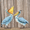 Our Persnickety Pelicans Coastal Inspired Garden Statuary comes as a set of 4. These metal pelican coastal garden birds are crafted from high quality metal, powder coated for added protection against weatherization, and individually hand painted for a unique one-of-a-kind outdoor decoration.  Whether you add them to your coastal home or rustic home, they will enhance any front lawn, backyard, or bird garden with their distressed coastal blue finish and stunningly detailed bodies and yellow beaks