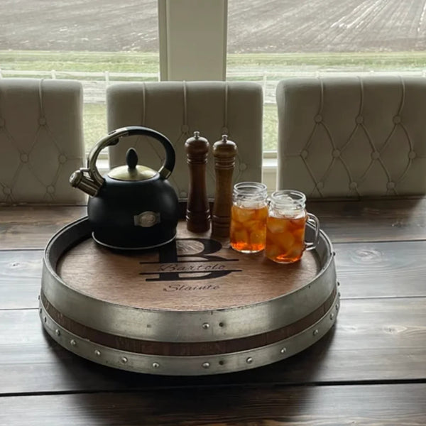 Shown is our Reclaimed Oak Wine Barrel Top Lazy Susan with Double Metal Rings with silver rings. This custom made to order piece is available in 5 finishes and 3 metal ring colors. It is 24” in diameter and made in the USA.