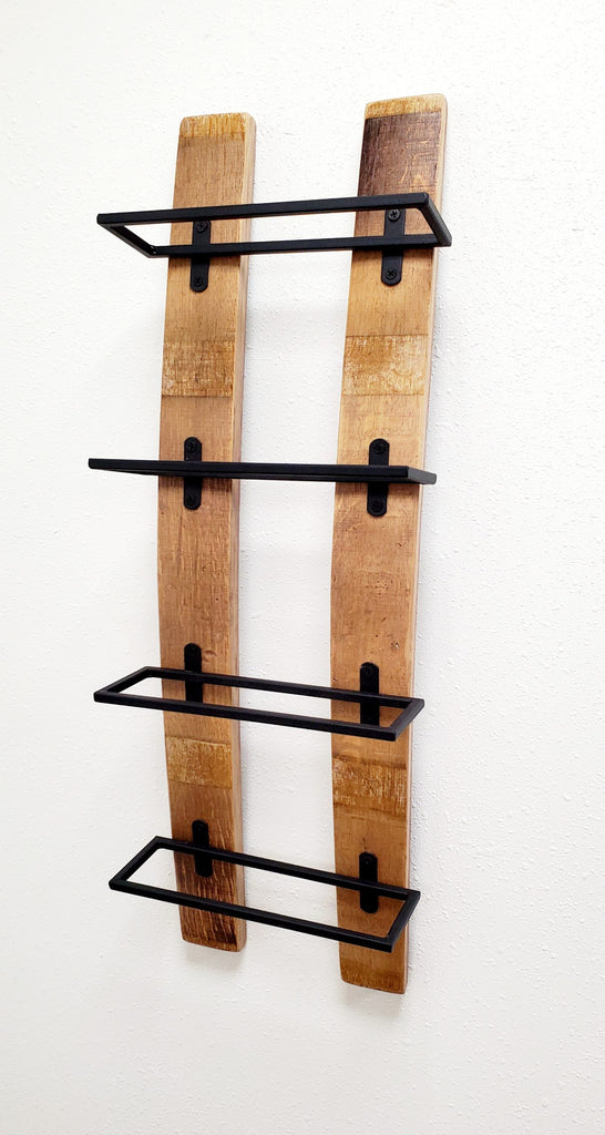 Our Reclaimed Oak Wine Barrel Staves Wall Mounted Wine Rack is made from recycled and reclaimed California oak wine barrels and crafted here in the USA, our skilled artisans have used wine barrel staves with four black iron open troughs to hold your one to four wine bottles in place while hanging on your wall. The contrast of the oak and black color is beautiful. This piece can also be customized to your perfection. Size is 29” tall x 9” wide.