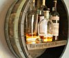Our Reclaimed Whiskey Barrel Head Cabinet Shelf is made from retired whiskey barrels that have been distinctively repurposed into whiskey barrel head wall décor that has a rustic, vintage style that is unique and purposeful. The shelf portion can be personalized with your own creativity or you can use one of our 3 premade sayings. This custom made to order item ships in 2-3 weeks. It is 21” in diameter by 7” deep.  Shown with engraving "What whiskey will not cure, there in no cure for."
