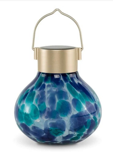 Our Tide Water Blue Hand Blown Glass Solar Tea Lantern is 5.5″ tall x 4.5″ wide and has been crafted by skilled artisans using hand blown glass techniques that create such eye catching detail