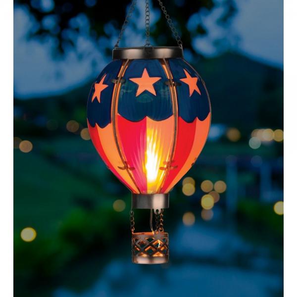 Evening view. Our breathtakingly beautiful Americana Solar LED Powered Hot Air Balloon Lantern features hand-painted glass panels of multi-colored hues, plus a string of flicker-happy LED lights, this lantern looks like a real hot air balloon. Hang it up and watch it glow for 6-8 hours with the included replaceable rechargeable batteries. Size is 5'' x 5'' x 15'' tall.
