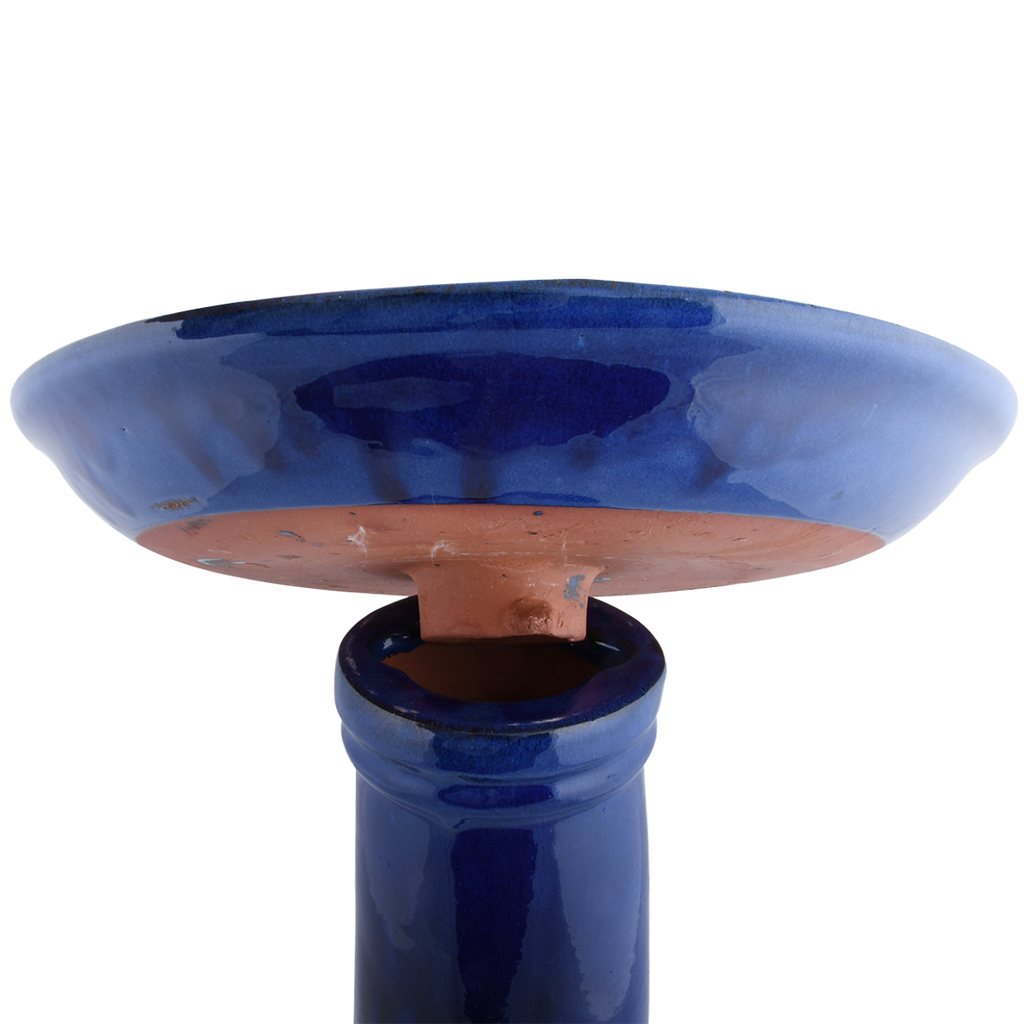 Shown locking top for our Cobalt Blue High Gloss Ceramic Birdbath Set will add luster and shine to your garden and provide birds fresh water to helps them thrive for both drinking and preening. This locking top system will ensure that your top will not get knocked off the flared bottom sturdy base. Inside of the bowl is an adorable ceramic bird figure, which will add a bit of whimsy and allow birds to sit on top while looking for a safe place to drink and bathe.