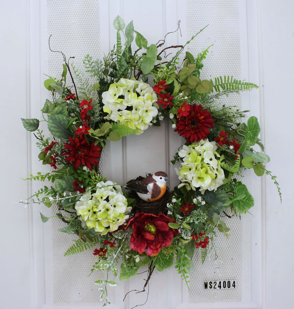 Our Nesting Among The Hydrangeas, Front Door Wreath  is a 24” in diameter twig based wreath with a nesting bird sitting front and center to welcome guests to your home. Our wise owl is surrounded by faux yellow flowers, with lots of greenery and an abundance of wispiness’ and ready to impress guests who come to your front door.   This wreath is handcrafted here in the USA and will be custom made for you by our skilled artisans who have an eye for detail.