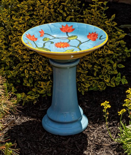 Our Pastel Blue High Gloss Hand Painted Porcelain Birdbath boasts a charming pastel blue finish with intricate sculpted accents as well as a hand painted birdbath bowl with coral flowers and greenery.