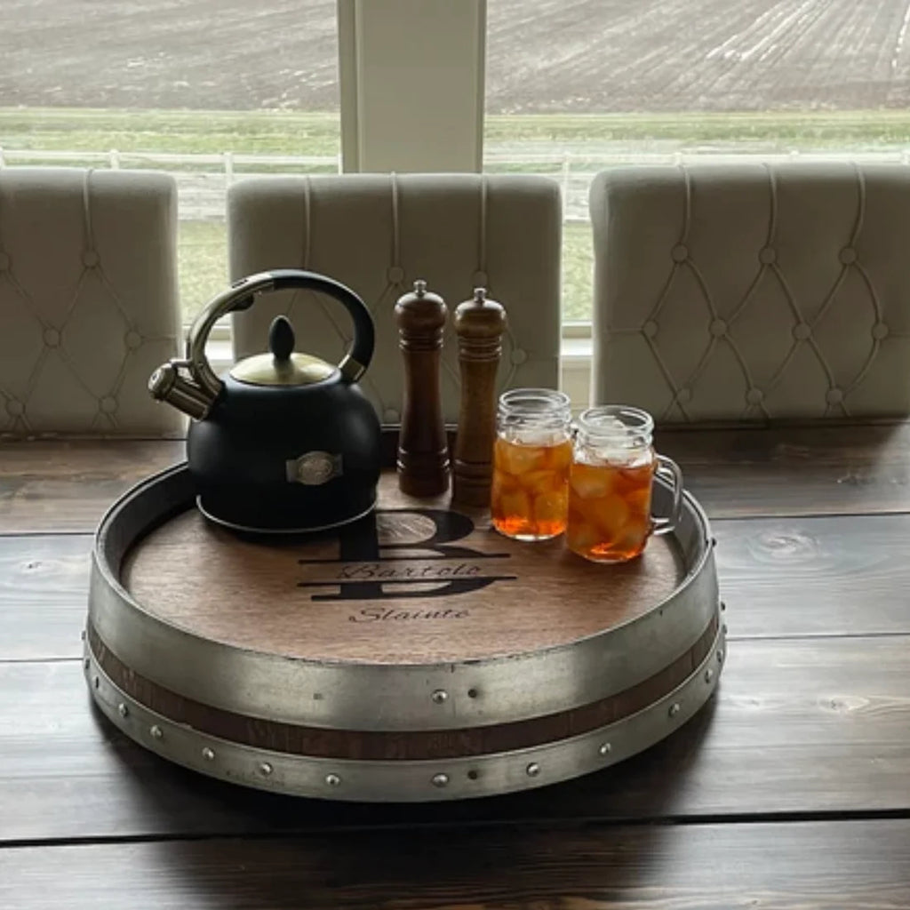 Shown is our Reclaimed Oak Wine Barrel Top Lazy Susan with Double Metal Rings with silver rings. This custom made to order piece is available in 5 finishes and 3 metal ring colors. It is 24” in diameter and made in the USA.