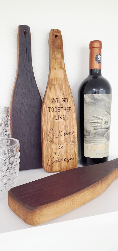 Our Reclaimed Wine Barrel Cheese Paddle Charcuterie Board with Inscription are food safe and crafted from recycled oak wood California wine barrels, this unique board offers an intriguing way to serve your favorite snacks or hang it on the wall for a touch of rustic decor. They are available in 3 inscriptions of your choice or no inscription at all. Size is 13.5” tall x 4” wide. 