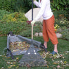 Our WheelEasy™ Folding Wheelbarrow Garden Cart will help you maintain your garden with no heavy or awkward lifting. Each cart features a pneumatic front tire with powder coated steel frame and collapsible soft sided heavy duty vinyl coated denier nylon canvas barrow, allowing you to lay it flat on the ground so you can load it up with a multitude of home and gardening projects. Shown with cart on the ground and lady sweeping in leaves .
