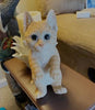 Our Orange Tabby Hanging Indoor Outdoor Kitty Statue features realistic details that have been handcrafted by skilled artisans. We show it hanging off the mirror on our car, but it is great hanging from a fence or add it to the side of a plant pot, hang it from your mantle. Size is 8.75"H x 5"W x 3.75"D. Shown sitting on a table.