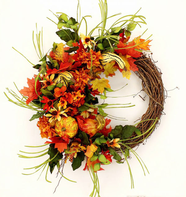 Our Autumn Gourds Grapevine Fall Front Door Wreath is 23" in diameter and features a grapevine wreath that is exposed on right side and then uniquely crafted on the other side with an assortment of orange and yellow silk flowers with lots of fall colors, and wispy straw and green leaves, gourds and tons of beauty 