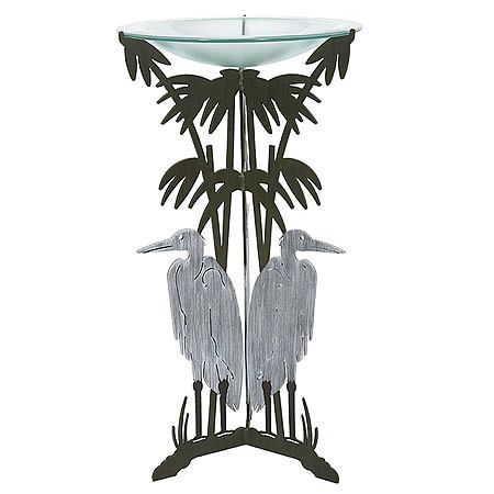 Our Blue Heron Birdbath Metal Art Sculpture is a stately piece hand forged here in the USA by skilled artisans. Fabricated by hand with the use of 3/16” heavy gauge steel, then zinc galvanized to prevent rusting, and hand painted with a two-step high quality marine grade epoxy paint for weather resistant indoor or outdoor use. The very sturdy tri-legged cattails pedestal base, once hand painted in silver and brown colors, is fitted, is then fitted with a 3/8” thick frosted glass bowl with flange.