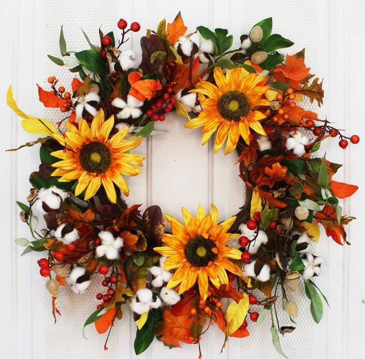 Handcrafted here in the USA, our Cotton and Sunflower Fall Front Door Wreath is 24 inches in diameter and features a stunning array of fall colors including cotton, berries, greenery, and sunflowers. This 24” in diameter wreath is ready to be proudly hung on your front door décor to capture curb appeal at its finest.