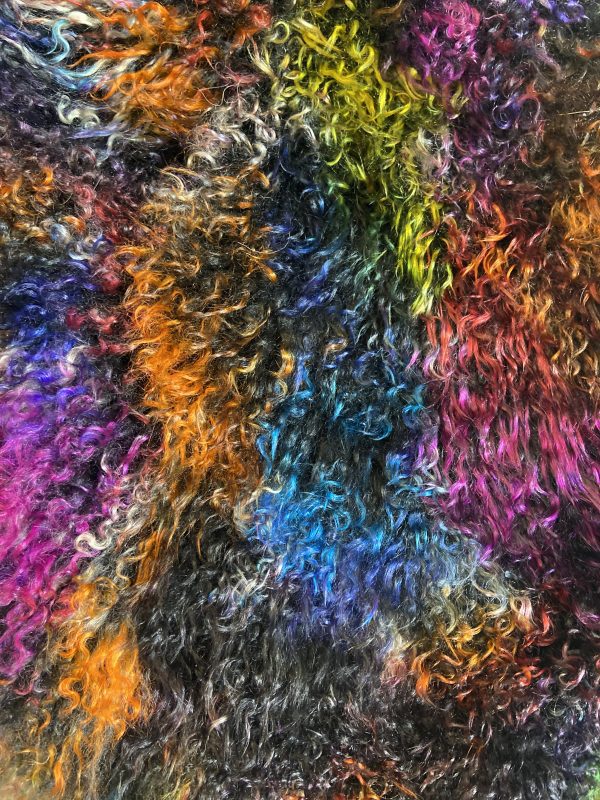 Our Dark Confetti, Multi-colored, Tibetan/Mongolian Lamb Fur Pillows are available in 16", 20" and 12"X20" sizes and features soft and fluffy natural curls that have had the strands and tips dyed in multiple colors.