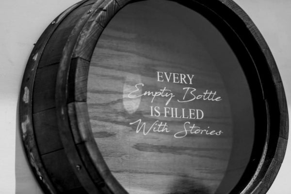 Shown in our ebony stain, this wall mountable Wine Barrel Head Cork Holder has been etched with Every Empty Bottle Is Filled With Stories. It is 21” in diameter x 7” deep and handcrafted, here in the USA, from the use of reclaimed and repurposed wine barrels, wine staves, barrel bands, and clear Plexiglas front, enabling you to view your collection of corks.  You can personalize the front of the Plexiglas with this memorable quote or a memorable quote of your choice.