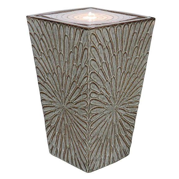 Our Embossed Ceramic Dahlia Tapered Square Fountain is an elegant, fully self-contained ceramic fountain with embossed dahlia will add color and tranquility to your patio, deck, or elsewhere in your home or garden. It includes a pump with LED light to enhance its beauty. Our glazed fountains are created by skilled artisan who have an eye for detail and a love for their craft.. Water will beautifully bubble and cascade down into the bowl below. Overall size is: 13.75” deep x 22” high.