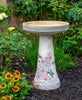 Our Hummingbird Handcrafted Clay Birdbath Set on asoft gray background is beautifully handcrafted and painted in the USA