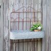 Our Metal Garden Fence Planter is made of wrought iron with an inground stake and resembles a garden fence. The planter bucket is made of galvanized steel and the contrasting color of the rust and silver is so pretty. This versatile planter can be used inground or hung on a wall or fence for a whole new look. Picture shows the planter hung on a wall.