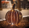 Our Orange Metal Indoor/Outdoor Pumpkin Candle Luminary  (shown at night) is 15” tall x 14” in diameter and has a large 6” opening for you to add your own flameless candle or 3-wick jar candle and you will immediately light up any space day or night. Our steel construction pumpkins are rust-proof, powder coated, UV resistant and so great for creating indoor or outdoor beauty, season after season. Also available in white and white mocha colors. 