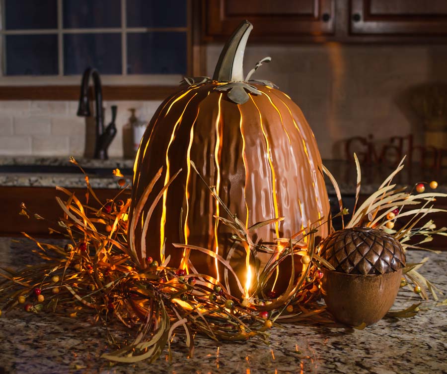  Our Orange Metal Indoor/Outdoor Pumpkin Candle Luminary is 18” tall x 12” in diameter and has a large 6” opening for you to add your own flameless candle or 3-wick jar candle and you will immediately light up any space day or night. Our steel construction pumpkins are rust-proof, powder coated, UV resistant and so great for creating indoor or outdoor beauty, season after season. Also available in white and expresso colors.  Shown with candle, not included.