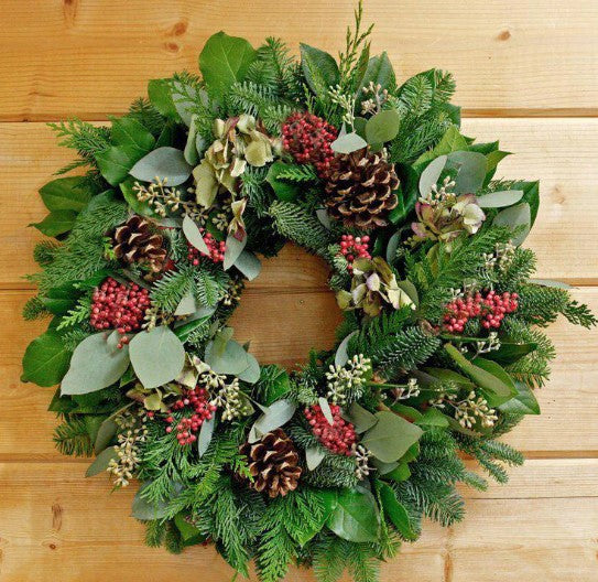Our Pinecones and Pepper Berries Christmas Winter Wreath is handcrafted with the use of Christmas greenery, pomegranates, pinecones, eucalyptus and pepper berries. Our 22” in diameter seasonal wreath will be handcrafted for you by skilled artisans here in the USA create the perfect holiday accent in your home