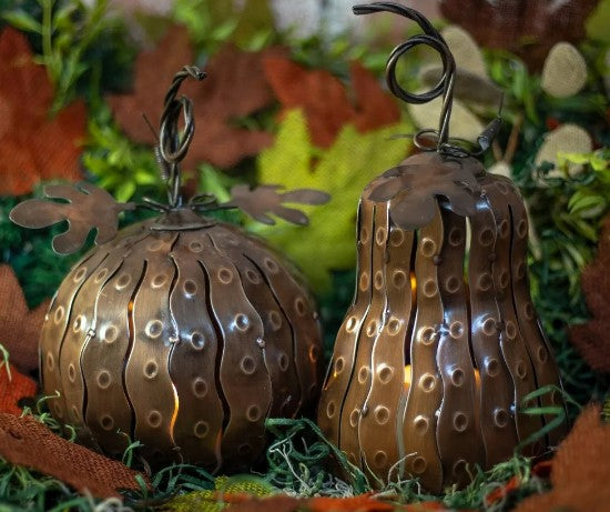 Our Pumpkin and Gourd Mini Luminary Lanterns are handcrafted from metal in a hammered finished coffee color and they are wonderful for indoor or outdoor use. They also look great scattered among our larger pumpkins as well. They can easily accommodate a flameless or tea light candle. Our pumpkin and gourd set makes for a magical statement for fall and beyond. 
