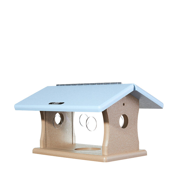 Our Recycled Poly Lumber Plastic Bluebird Feeder - Taupe and Blue is made in the USA. This poly-lumber bluebird feeder is made from recycled plastic and milk jugs that make for a sturdy product that comes with a lifetime guarantee to never crack, split or fade. Poly-lumber is, literally, tough as nails. The feeder features two tone blue roof and taupe colored base that is 5/8 inches in thickness. Additional features are shown below. Size is 13.5"L x 10.25"W x 8"H. Shown with plexi-glass entry holes.
