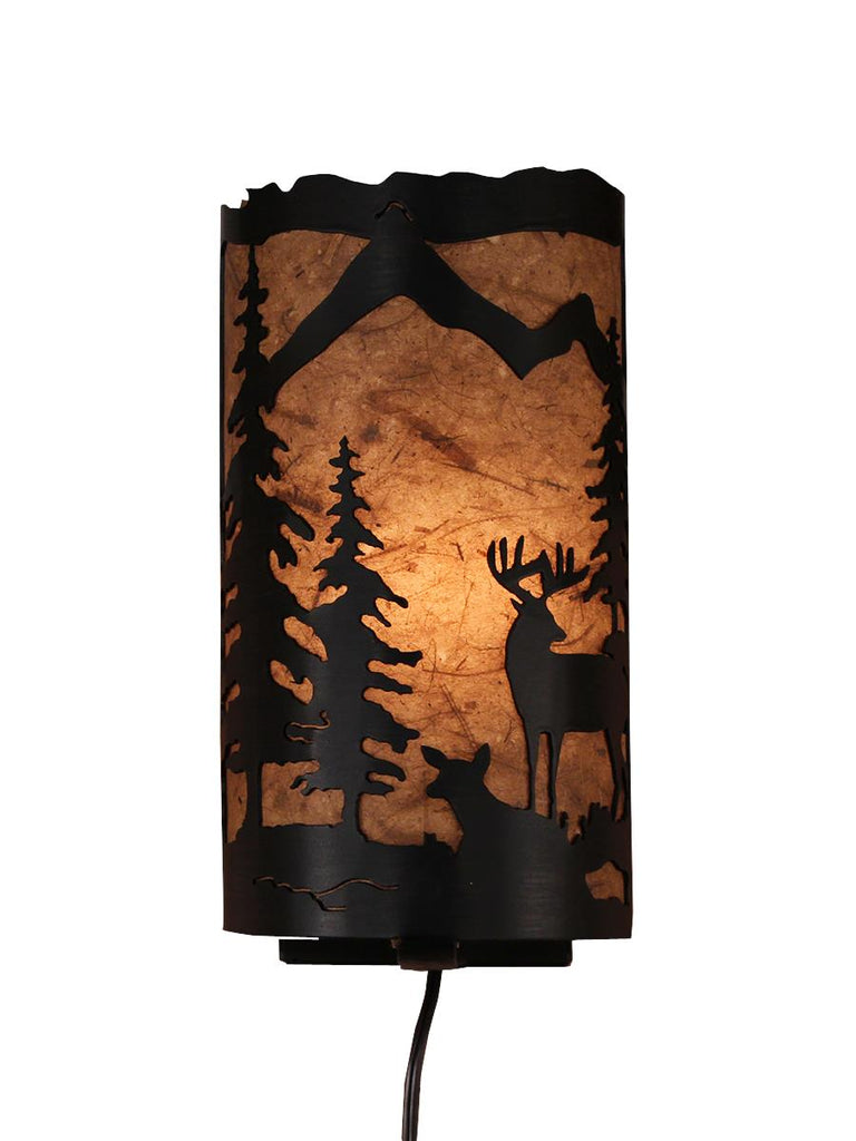 Our Rustic Deer Panel Wall Sconce captures the forested beauty with cutouts of metal deer and trees in front of the amber parchment paper shade