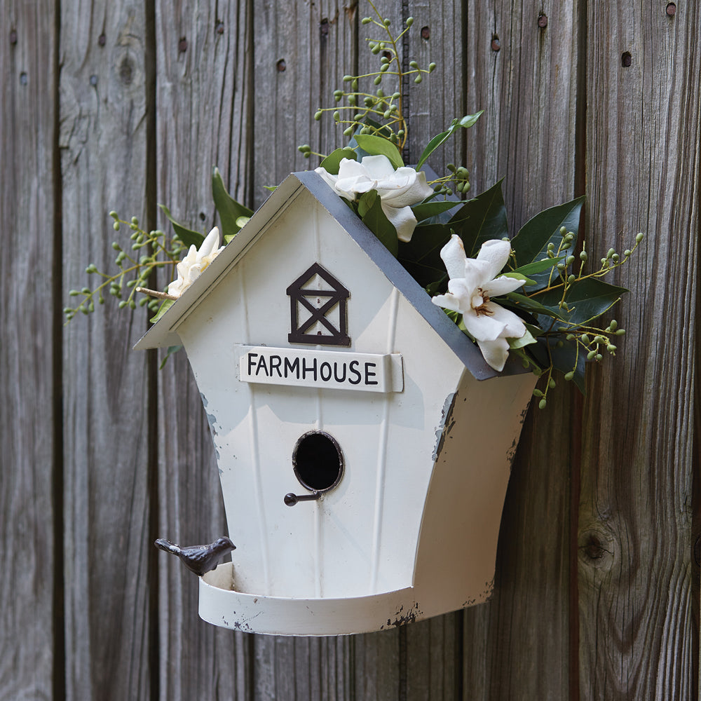 Our Rustic Farmhouse Distressed Metal Birdhouse / Wall Décor Planter is a multi-functional metal birdhouse with a touch of rustic décor will look great any place in your garden. The distressed white finish looks great on a tree, fence and even indoors on a wall. It has a cutout on the top to add faux plants, making it decorative for both indoor and outdoor use.