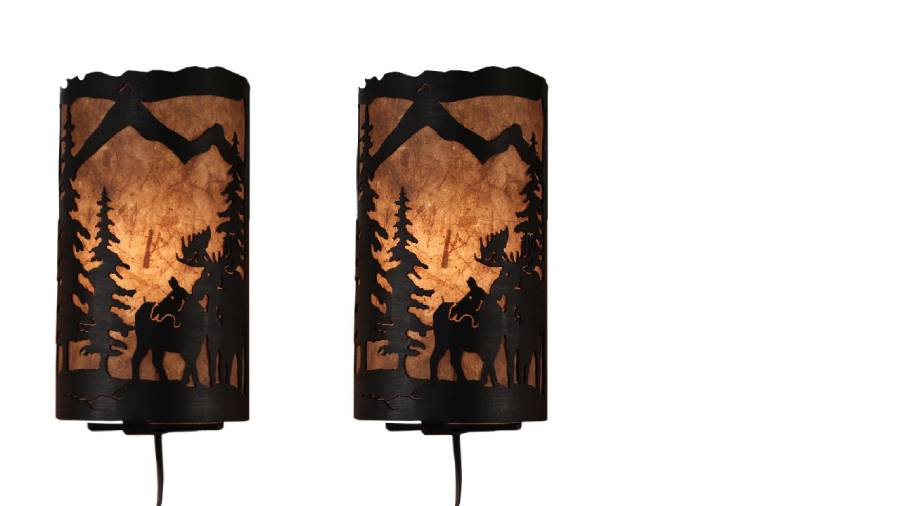 Our Rustic Moose Panel Wall Sconces (set of 2) captures the forested beauty with cutouts of metal moose and trees in front of the amber parchment paper shade