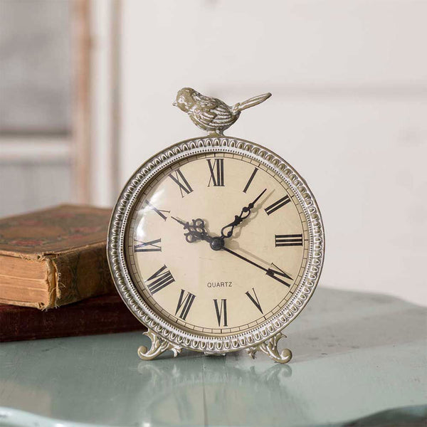 Our Songbird Decorative Tabletop Clock is a smaller clock to add to that space that just needs a bit of décor to add style as well a function to. It is made of metal with Roman Numeral numbers on the face to tell time. Requires one AA battery. Size is 5½" wide x 1½" deep  x 7" high