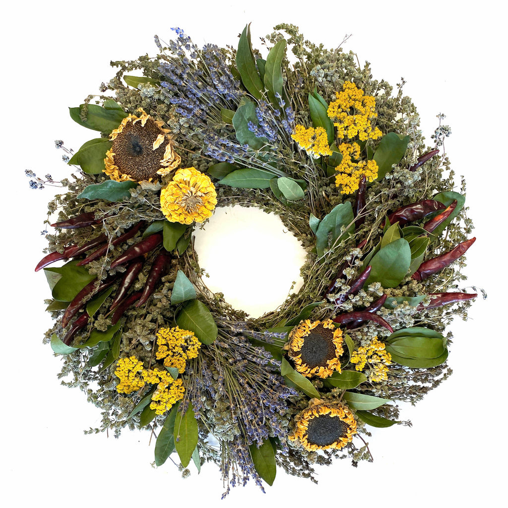 Our Sunflower and Herb Dried and Preserved is available in 2 sizes, 18” and 22” and handcrafted here in the USA from all hand grown and picked florals which have been dried to perfection. It does include a few fresh natural ingredients as well.  This is the 18" size wreath.