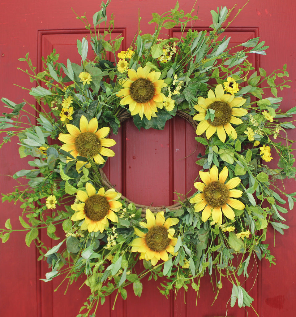 Our Sunsational Sunflowers Wispy Silk Front Door Wreath – 22” features lots of yellow sunflowers and greenery and great for many seasons of color