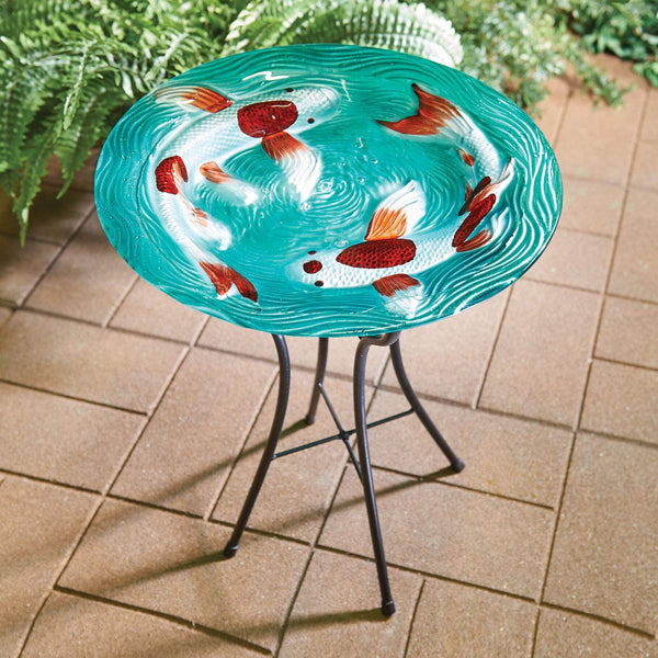 Our Swimming Koi Fish Glass Birdbath Set features a decorative and vibrant glass birdbath bowl with textured bottom. The bowl is crafted from durable, heavy duty textured glass and is outdoor safe and fade resistant, allowing it to make a yard art statement in your garden season after season. The accompanying powder coated stand is made of metal and can easily be folded away for easy storage. Size is 23.23” tall x 18” in diameter.