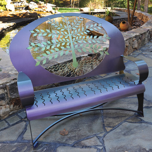 Shown in an outdoor setting, our Tree of Life Indoor Outdoor Metal Bench Sculpture is a custom made to order creation and hand forged by skilled craftsmen here in the USA. It is truly a metal garden art sculpture that will be a showpiece in your home or garden for years to come.