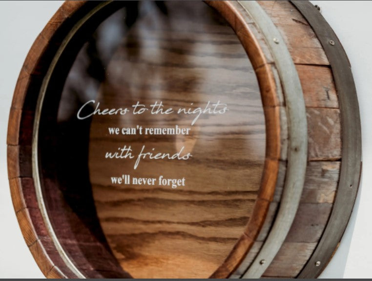 Shown in our walnut stain, this wall mountable Wine Barrel Head Cork Holder has been etched with Cheers to the Nights We Can’t Remember With Friends We’ll Never Forget. It is 21” in diameter x 7” deep and handcrafted, here in the USA, from the use of reclaimed and repurposed wine barrels, wine staves, barrel bands, and clear Plexiglas front, enabling you to view your collection of corks.  You can personalize the front of the Plexiglas with this memorable quote or a memorable quote of your choice.