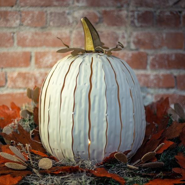  Our White Metal Indoor/Outdoor Pumpkin Candle Luminary is 18” tall x 12” in diameter and has a large 6” opening for you to add your own flameless candle or 3-wick jar candle and you will immediately light up any space day or night. Our steel construction pumpkins are rust-proof, powder coated, UV resistant and so great for creating indoor or outdoor beauty, season after season. Also available in orange and expresso colors. 