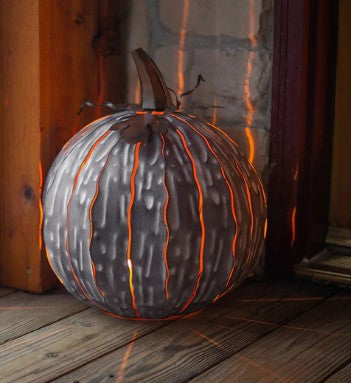 Our White Mocha Metal Indoor/Outdoor Pumpkin Candle Luminary (shown at night)  is 15” tall x 14” in diameter and has a large 6” opening for you to add your own flameless candle or 3-wick jar candle and you will immediately light up any space day or night. Our steel construction pumpkins are rust-proof, powder coated, UV resistant and so great for creating indoor or outdoor beauty, season after season. Also available in white and orange colors. 