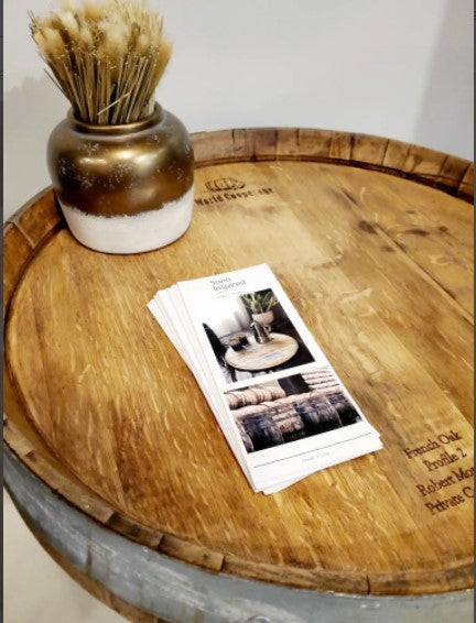 Shown is our 24” in diameter Wine Barrel Head Lazy Susan With Ring and Original Barrel Stamps, finished our clearcoat stain. Each unique piece is handcrafted here in the USA from reclaimed and repurposed authentic wood wine barrel heads. The lazy susan features the original wine barrel with ring as well as the winemakers original barrel stamps/markings that were added when the wine was being stored and fermented. 