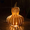Our Yellow Gourd Indoor/Outdoor Candle Luminary Lantern is handcrafted from all weather steel gourd will certainly make a statement indoors or outdoors. The bottom of the gourd is open to add a flameless candle, 3-wick jar candle or battery puck light of your choice. The pretty yellow color looks great by itself or added to one of our pumpkin luminary lanterns. Size is 12”W x 15.5”H. Shown with lit candle.