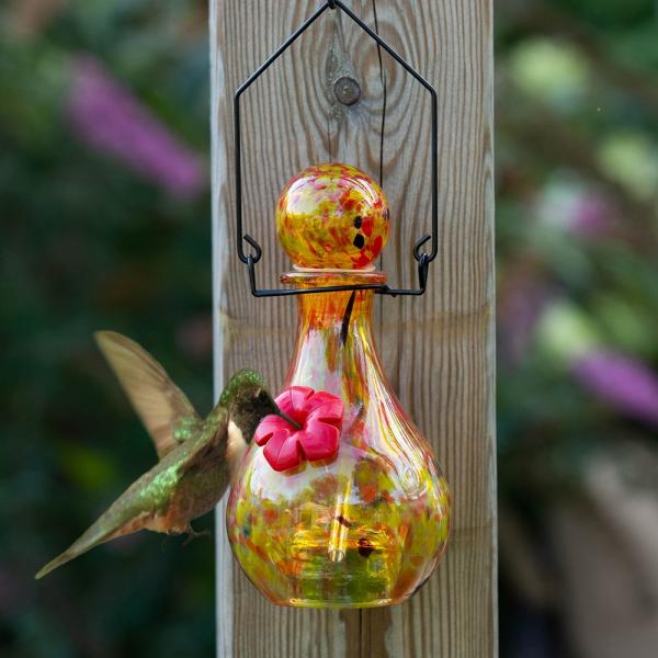 This vase style glass hummingbird feeder is beautiful by day, and exquisite by night. It has been skillfully handcrafted from blown glass and will certainly add color, light and decoration to your garden. Size is 4.25" x 4.25" x 8.25."